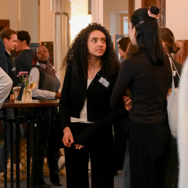 Aida van Riel talking with other attendees at an ISPOR conference session